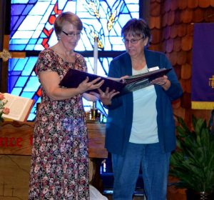 Linda Presenting Pastor Melanie's Scrapbook